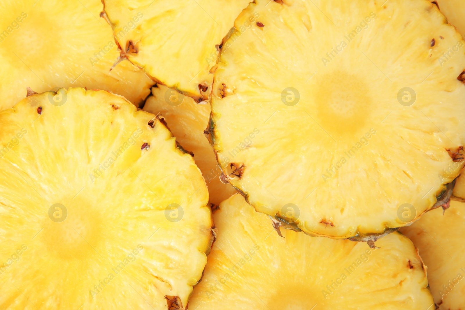 Photo of Slices of tasty ripe pineapple as background, top view