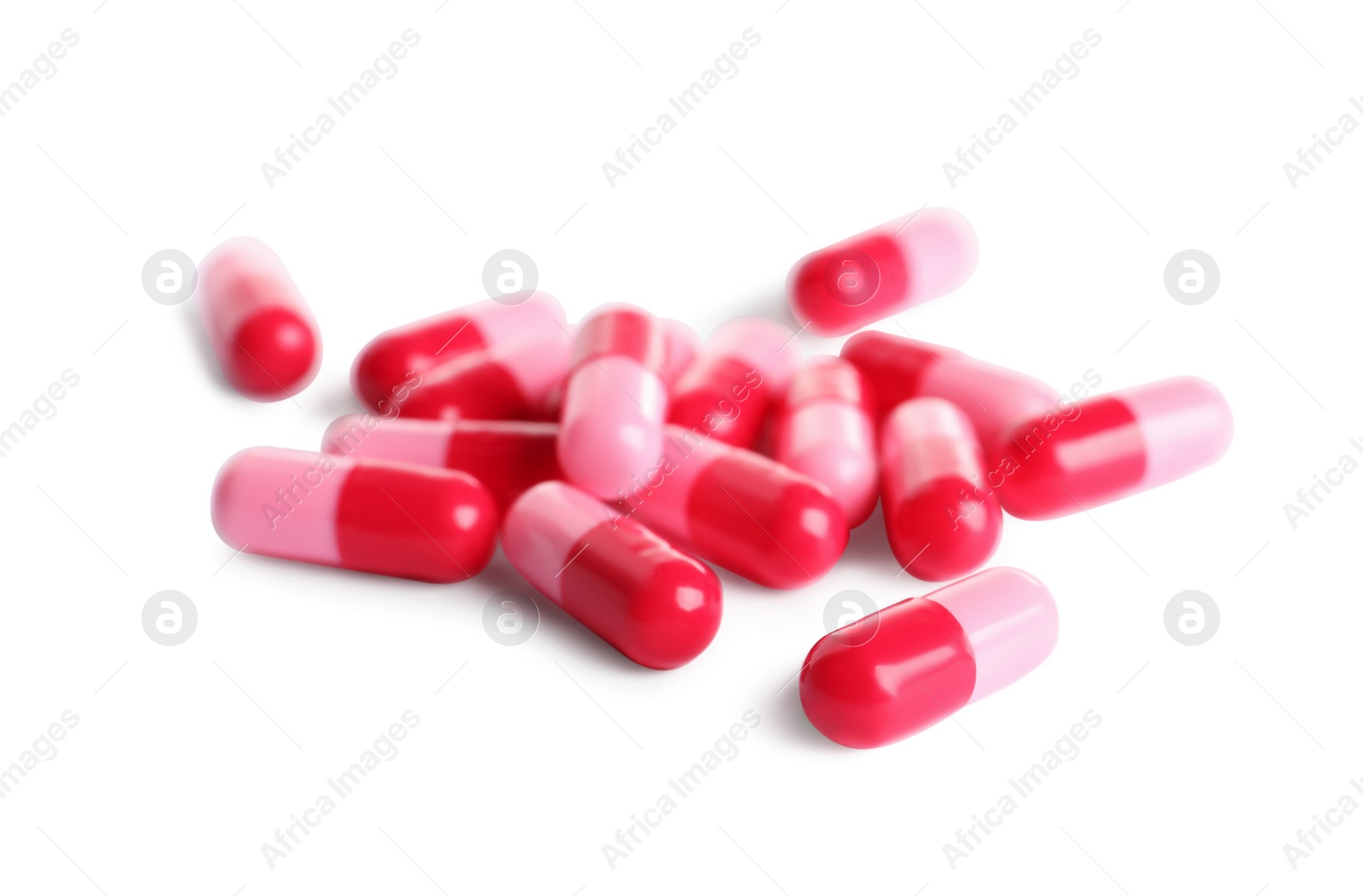 Photo of Many pink pills isolated on white. Medicinal treatment