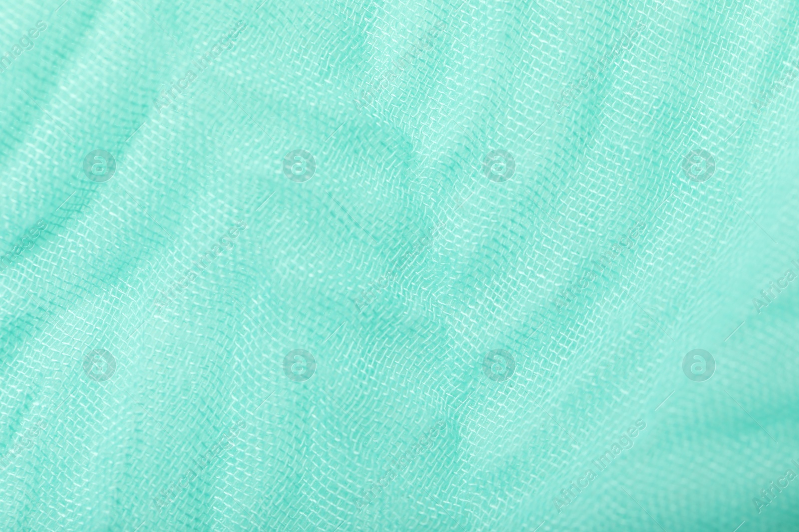 Photo of Texture of turquoise fabric as background, top view