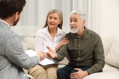 Photo of Notary consulting senior couple about Last Will and Testament in office