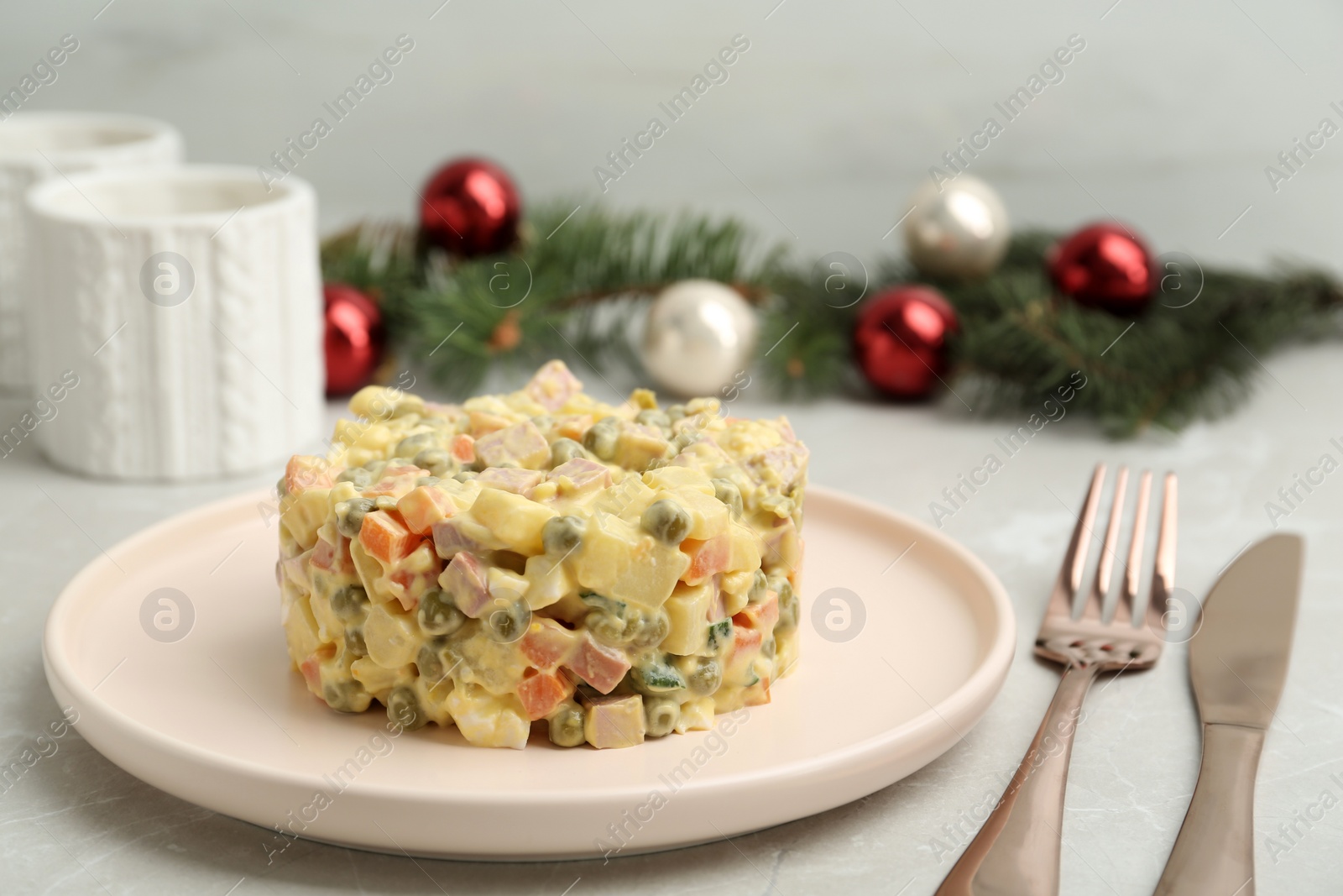 Photo of Fresh Russian salad Olivier served on grey table