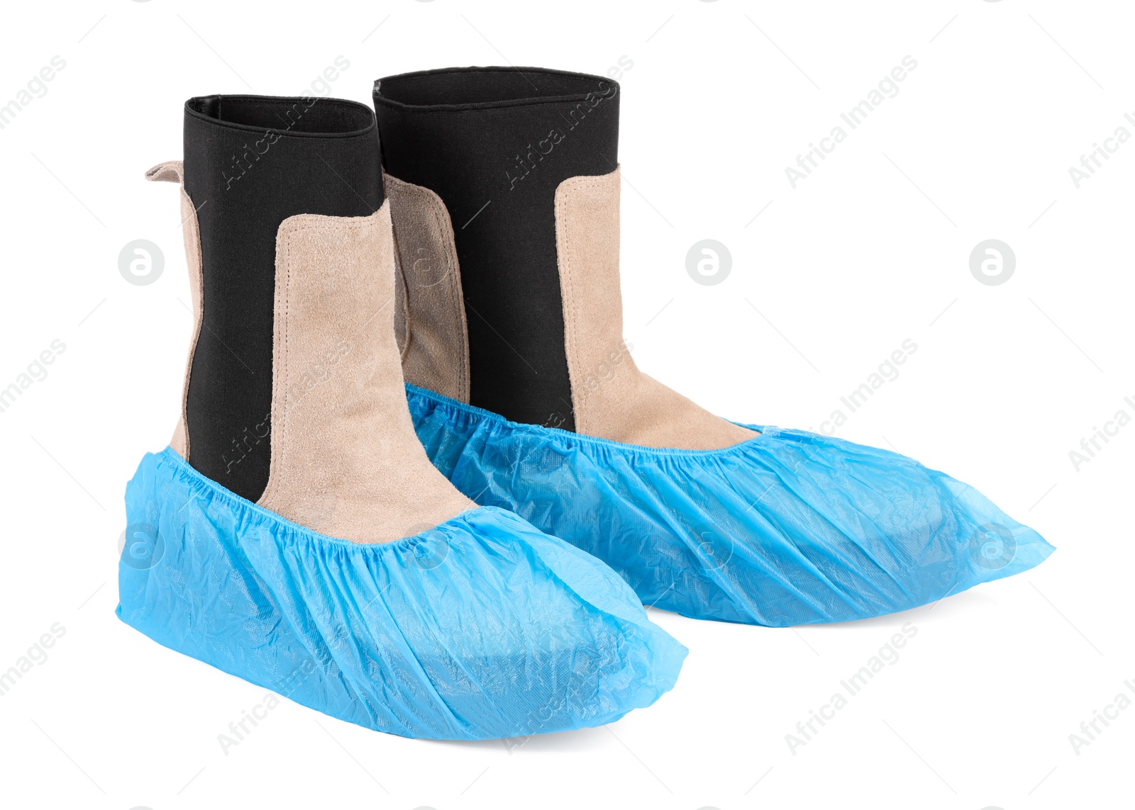 Photo of Women's boots in blue shoe covers isolated on white