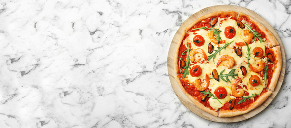 Image of Top view of hot delicious pizza on white marble table, space for text. Banner design 