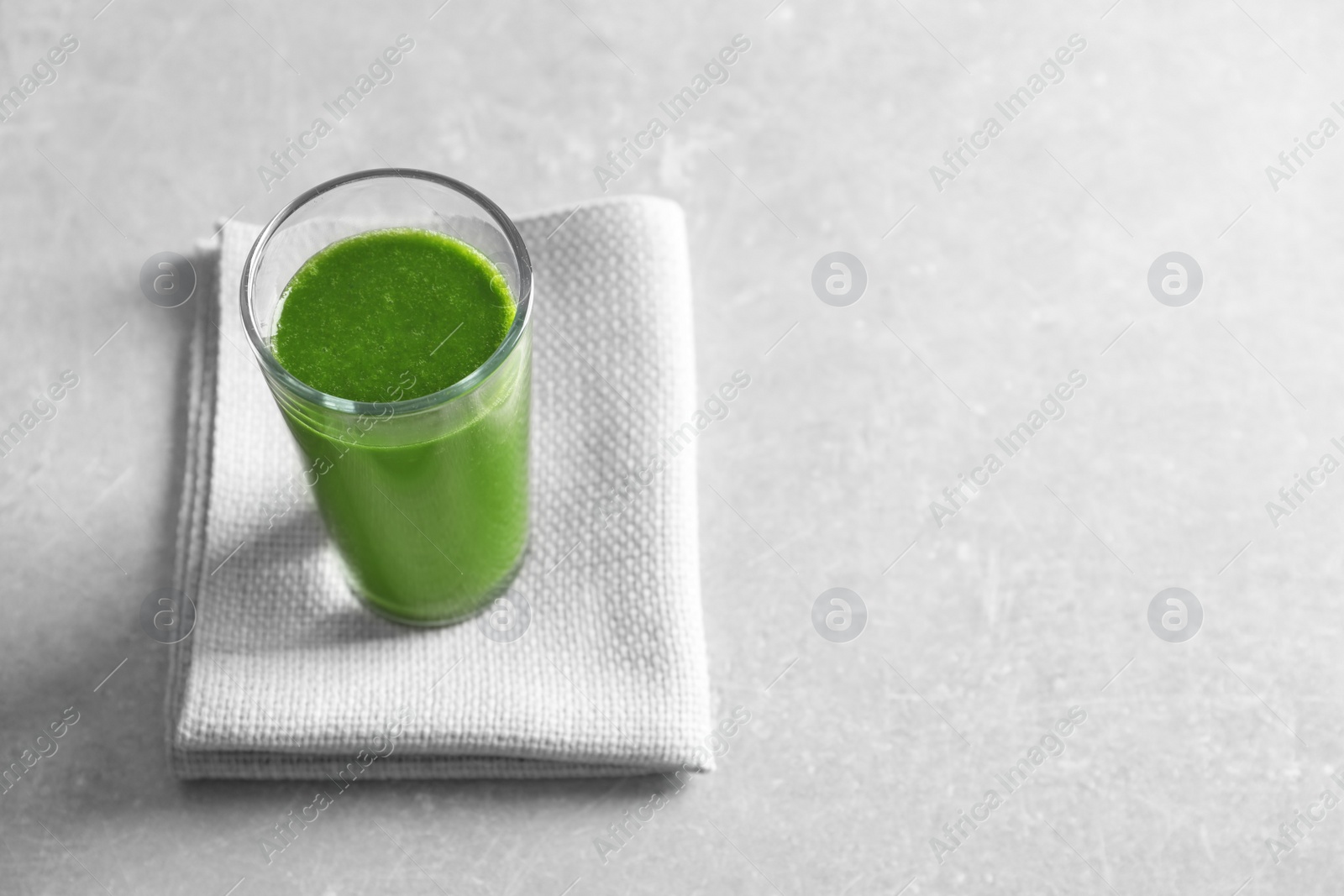 Photo of Glass with delicious detox juice on table