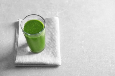 Photo of Glass with delicious detox juice on table