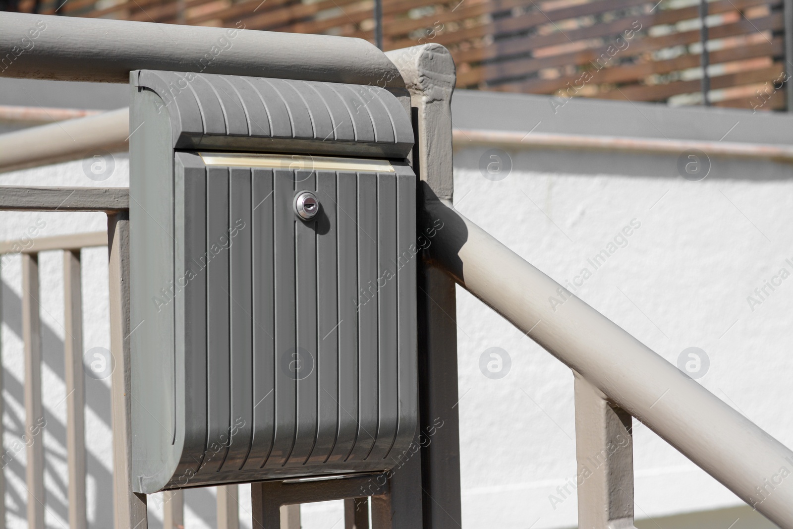 Photo of Beautiful metal letter box on railing outdoors