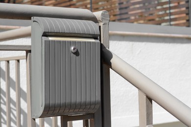 Beautiful metal letter box on railing outdoors