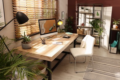 Photo of Light room interior with comfortable workplace near window