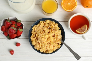 Photo of Flat lay composition with healthy cornflakes in bowl on wooden table