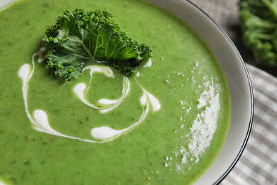 Photo of Tasty fresh kale soup on table, closeup view