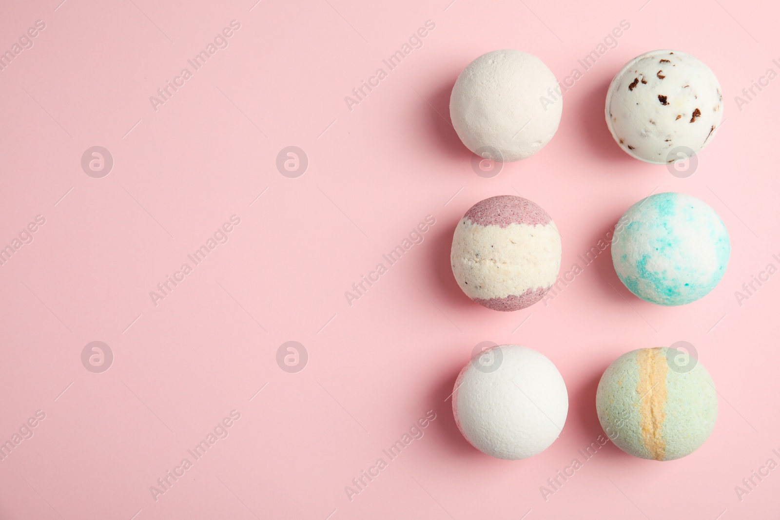 Photo of Flat lay composition with bath bombs and space for text on color background