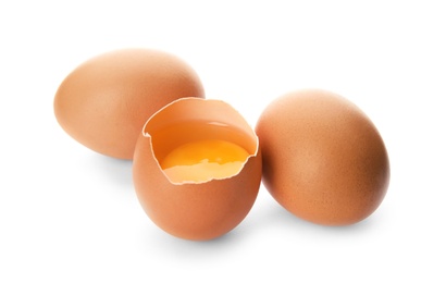 Photo of Raw brown chicken eggs on white background