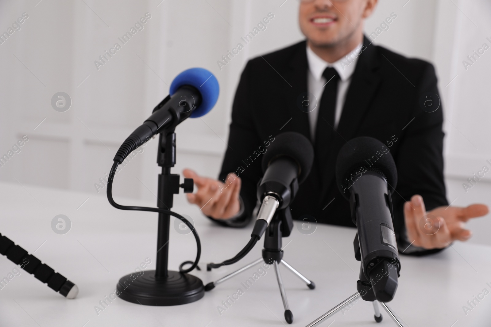 Photo of Business man giving interview at official event, closeup