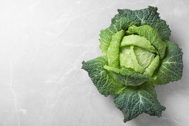 Photo of Fresh green savoy cabbage on marble table, top view. Space for text