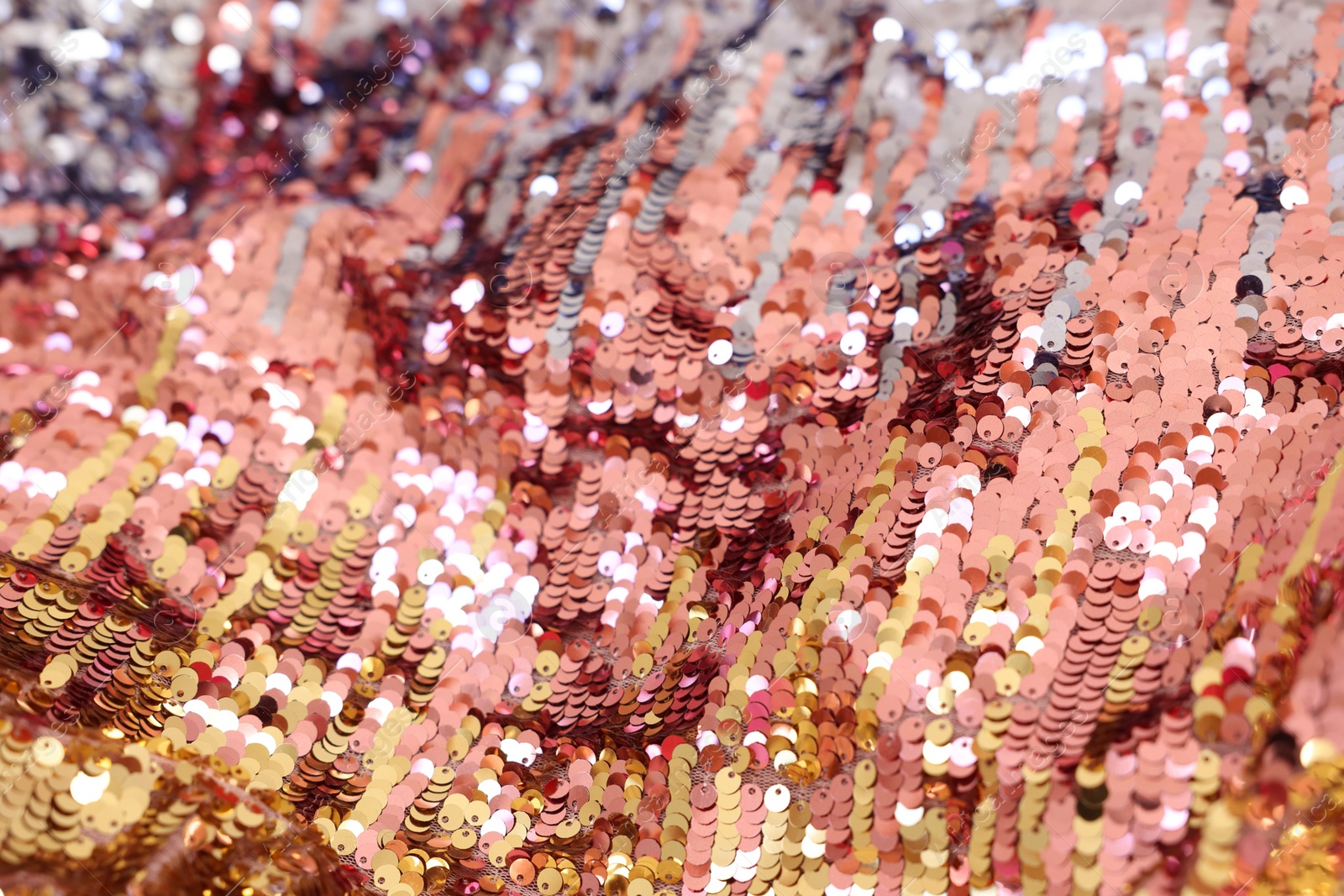 Photo of Texture of stylish pink carnival dress with sequins as background, closeup