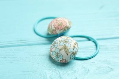 Cute hair scrunchies on light blue wooden table