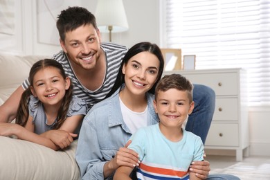 Photo of Portrait of happy family in living room. Adoption concept