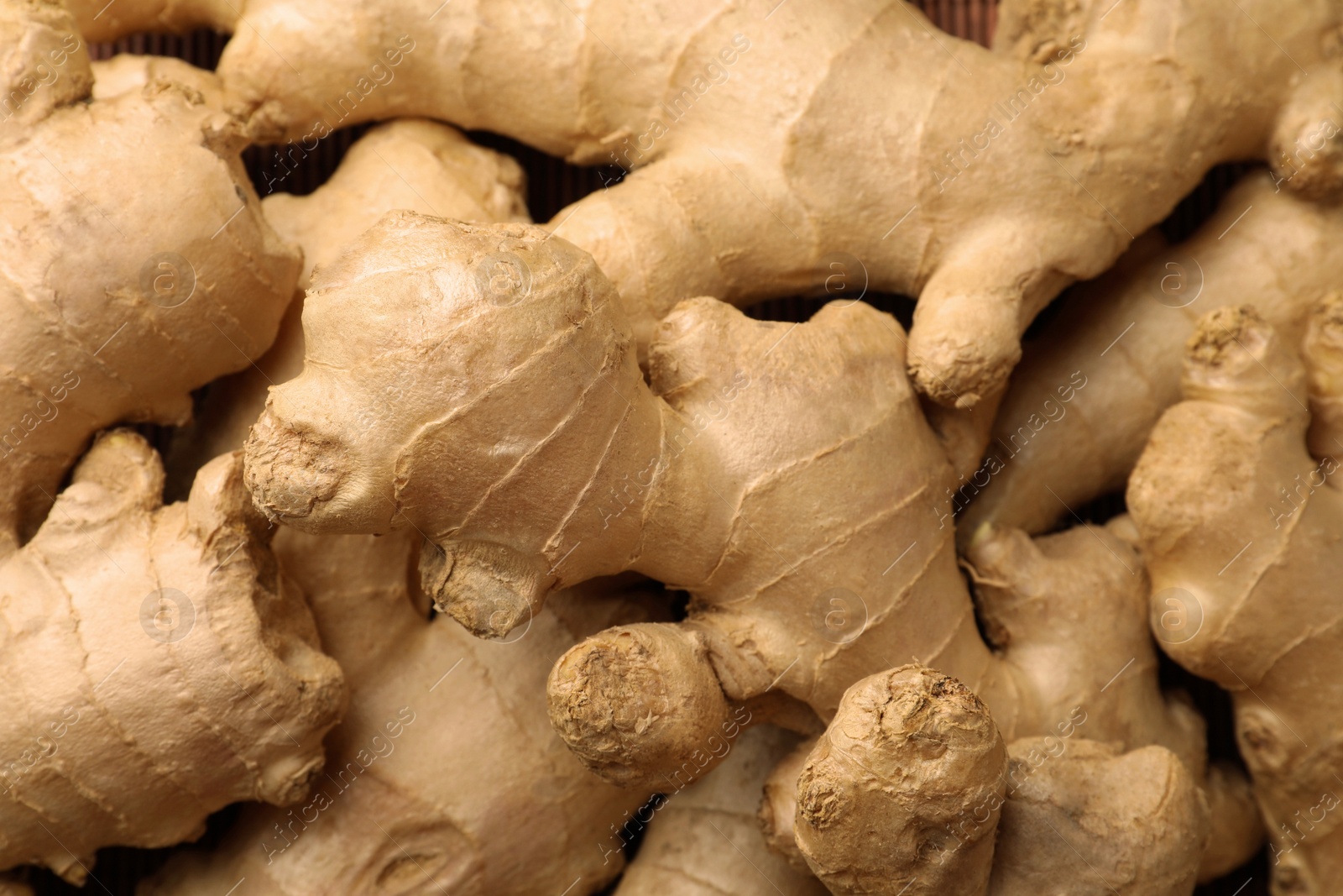 Photo of Aromatic fresh ginger as background, closeup view