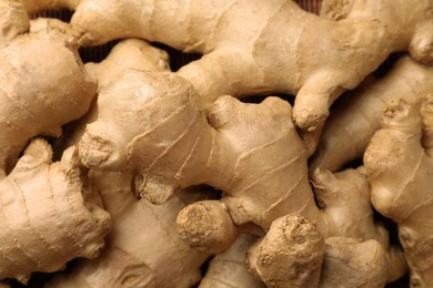 Aromatic fresh ginger as background, closeup view