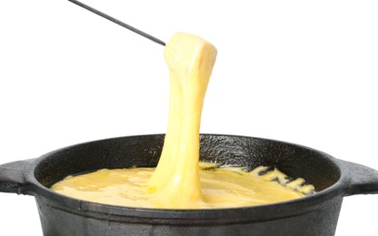 Photo of Dipping piece of ham into fondue pot with tasty melted cheese isolated on white