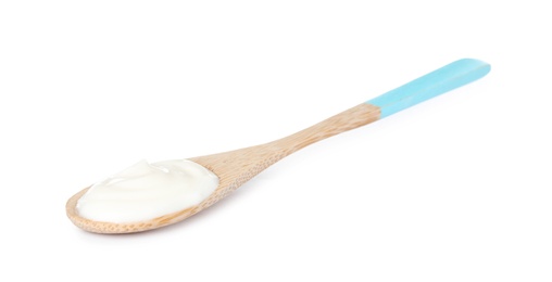 Photo of Wooden spoon with sour cream on white background