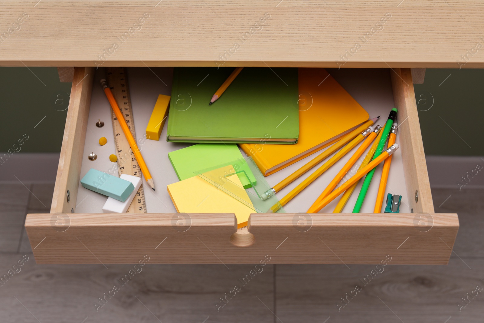 Photo of Office supplies in open desk drawer indoors