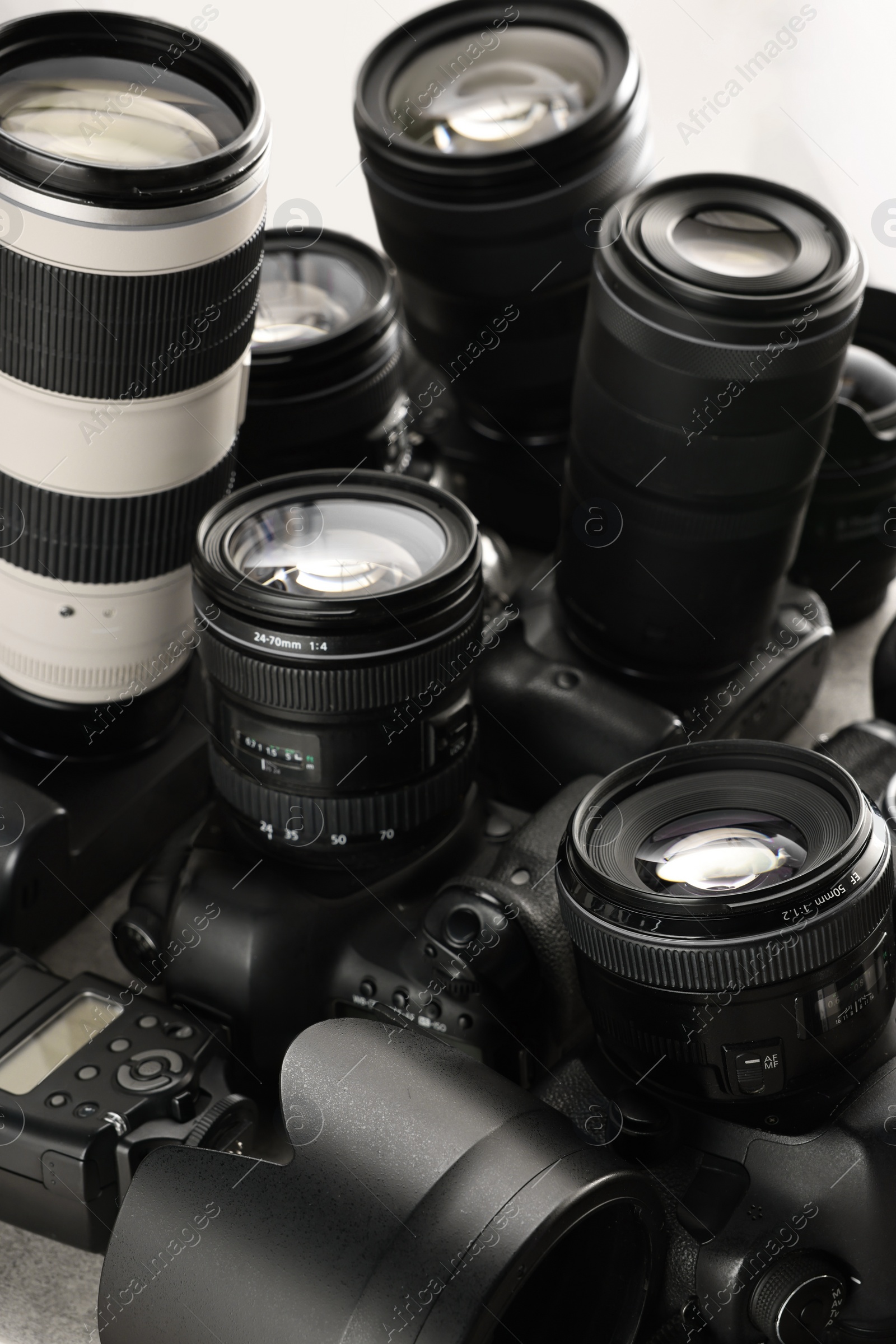 Photo of Modern cameras on table, closeup. Professional photography equipment