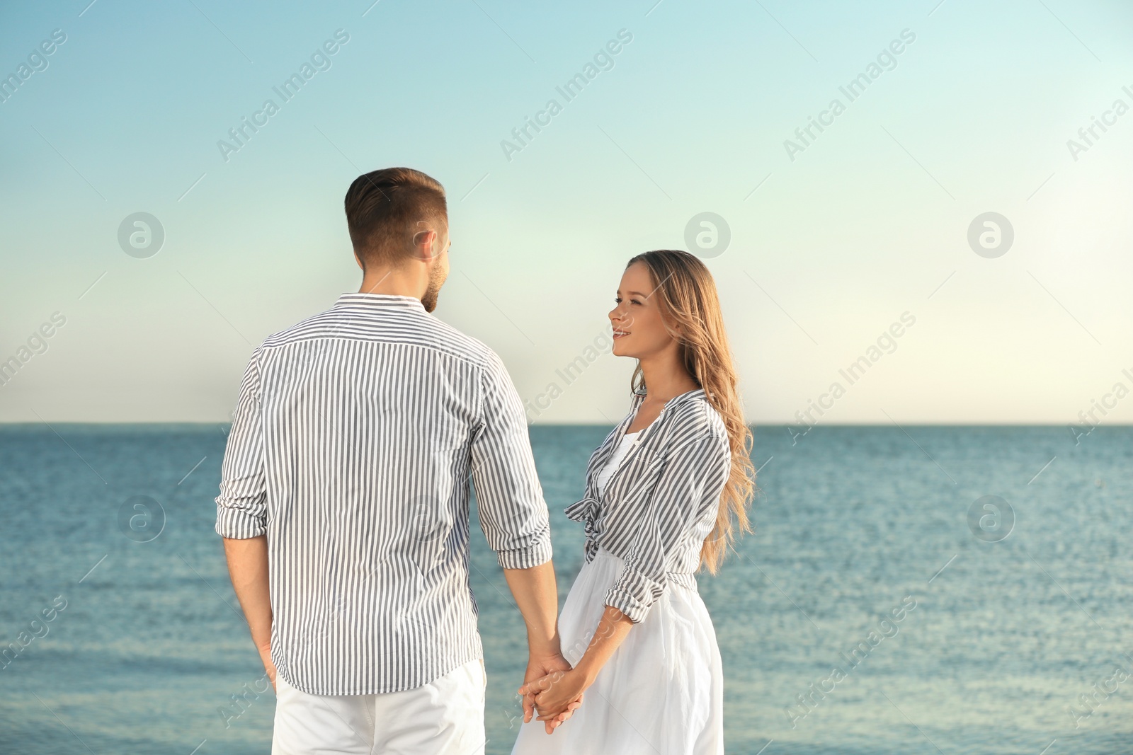 Photo of Happy young couple resting together on beach