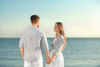 Happy young couple resting together on beach