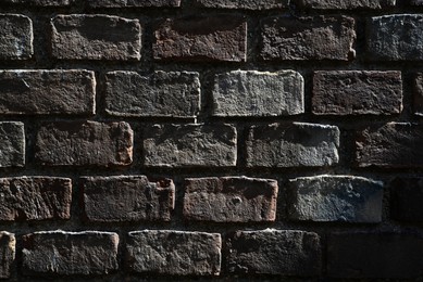 Photo of Texture of dark brick wall as background, closeup view