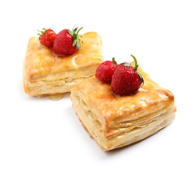 Fresh delicious puff pastry with sweet strawberries on white background