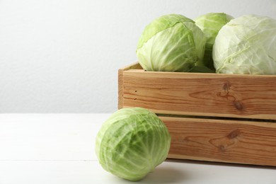 Photo of White cabbage in crate on table. Space for text