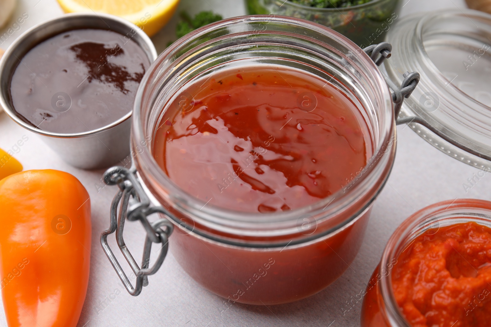 Photo of Different marinades in tableware on table, closeup