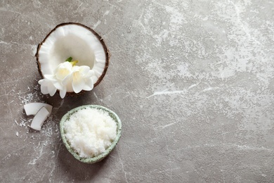 Bowl with natural coconut scrub on grey background