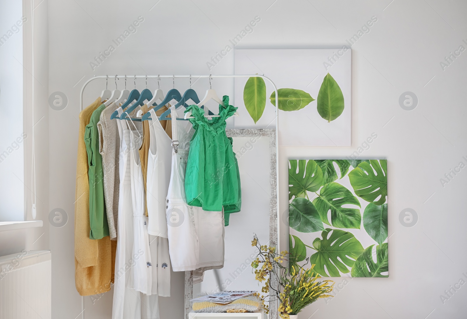 Photo of Stylish dressing room interior with clothes rack and mirror