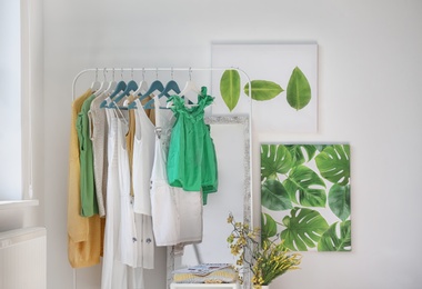 Photo of Stylish dressing room interior with clothes rack and mirror