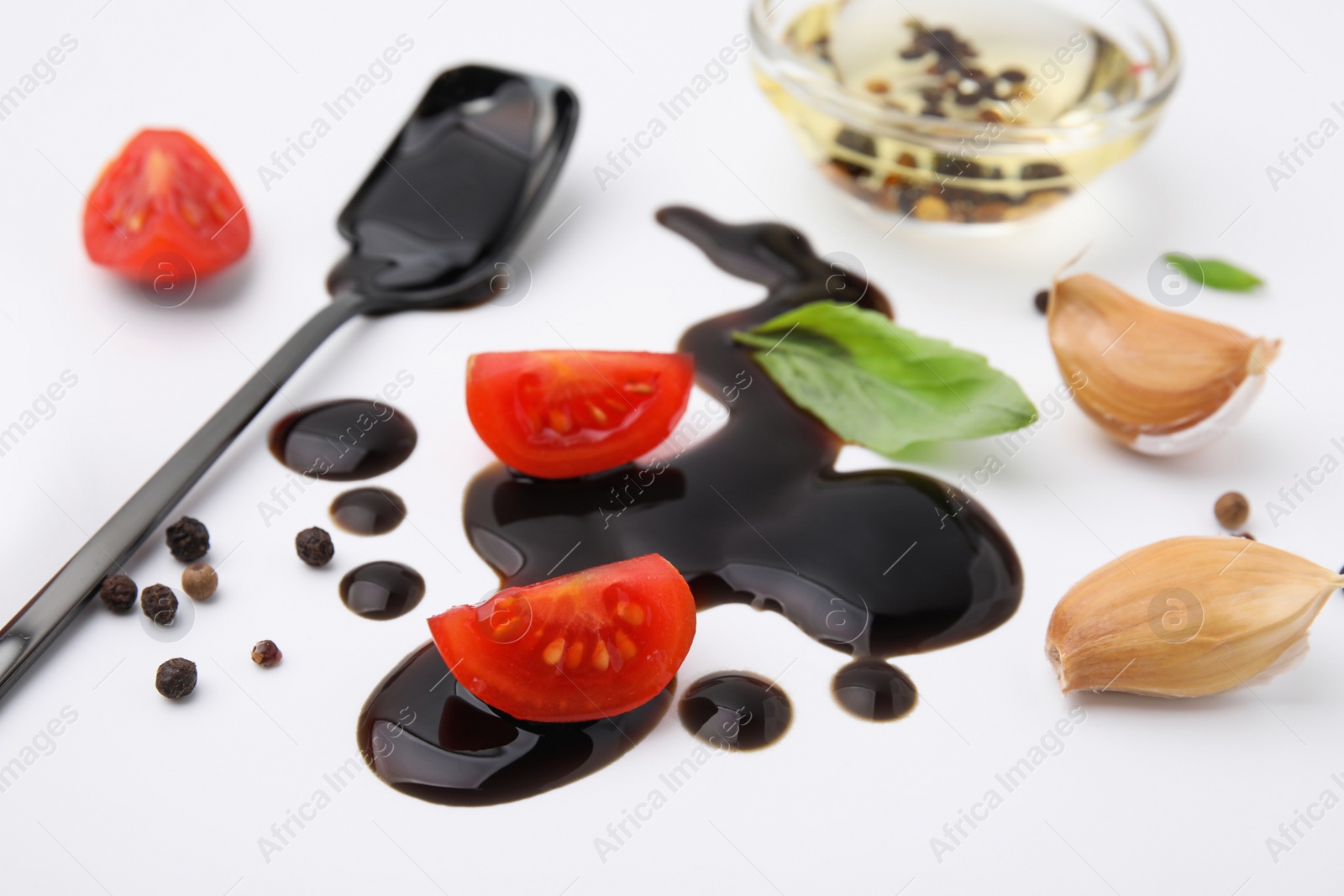 Photo of Organic balsamic vinegar and cooking ingredients on white background