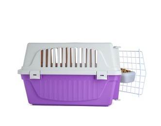 Violet pet carrier with bowl of dry food isolated on white