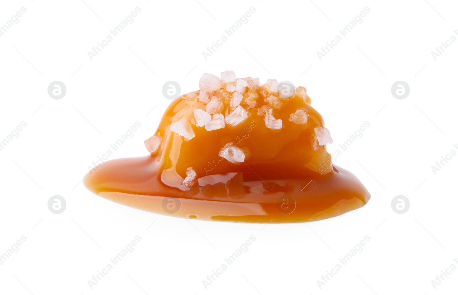 Photo of Yummy caramel candy and sea salt isolated on white