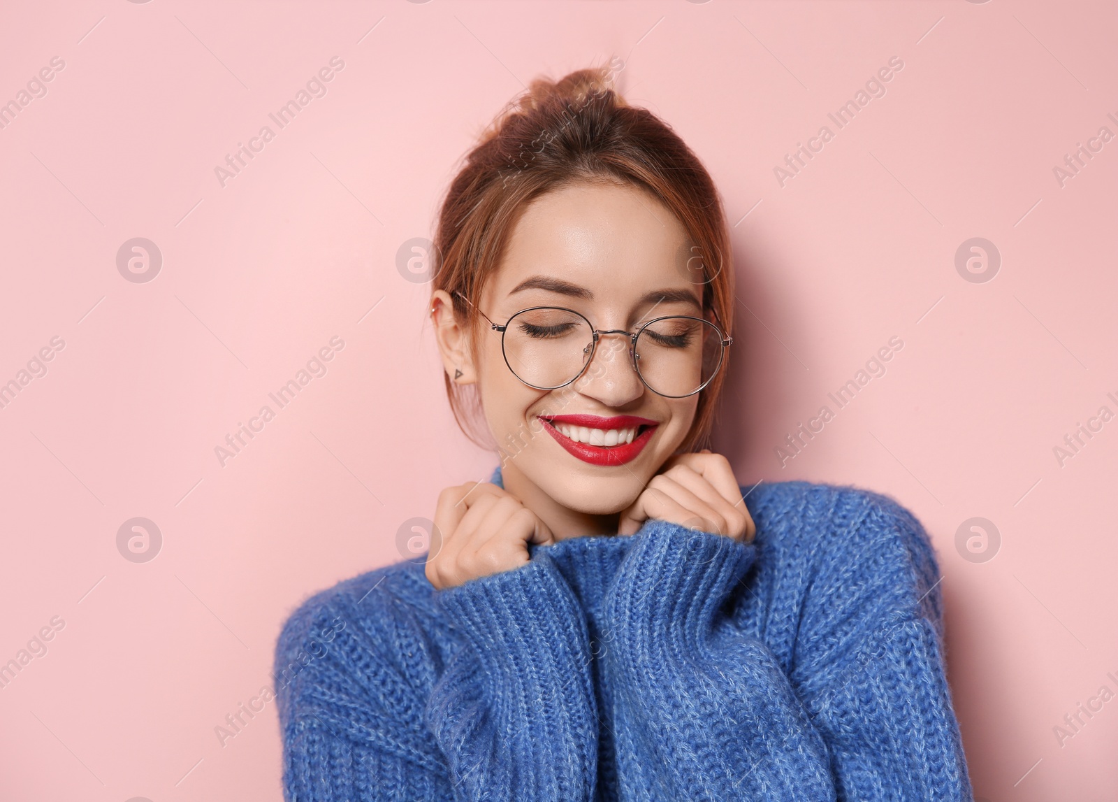 Photo of Beautiful young woman in warm sweater on color background