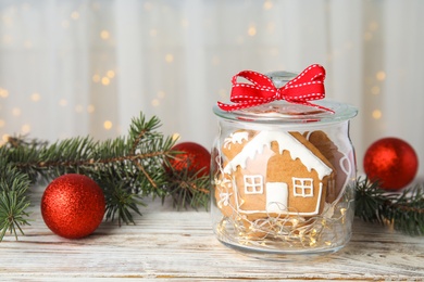 Photo of Glass jar with tasty homemade Christmas cookies on table