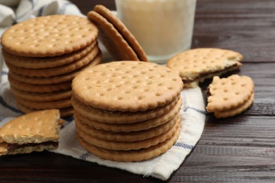 Tasty sandwich cookies on wooden table, closeup