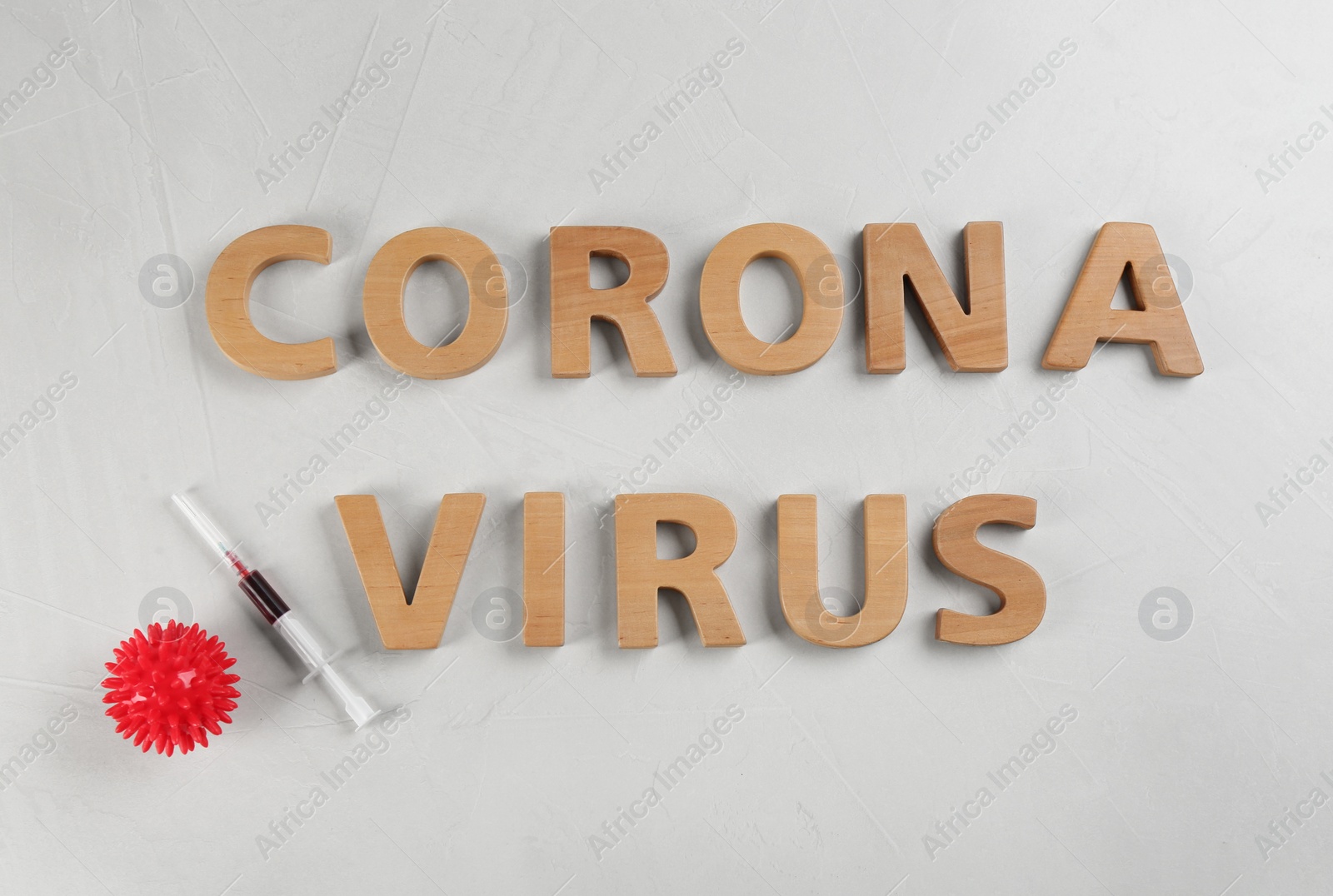 Photo of Words CORONA VIRUS and syringe on light background, flat lay