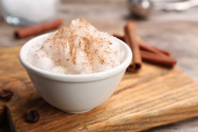 Photo of Bowl of tasty snow ice cream on wooden board, closeup. Space for text