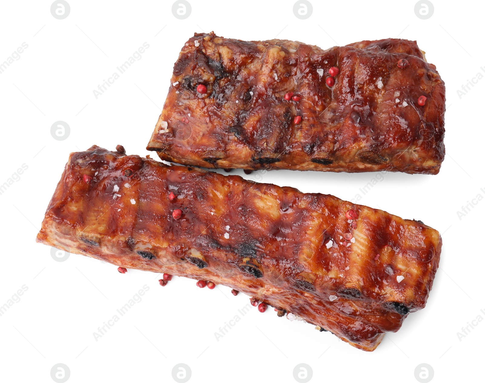 Photo of Tasty roasted pork ribs and peppercorns isolated on white, top view