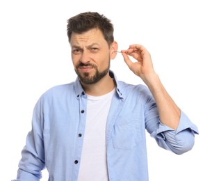 Emotional man cleaning ears on white background