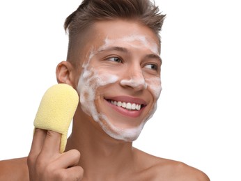 Happy young man washing his face with sponge on white background