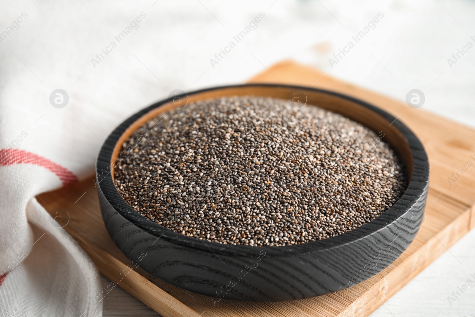 Photo of Plate with chia seeds on wooden board