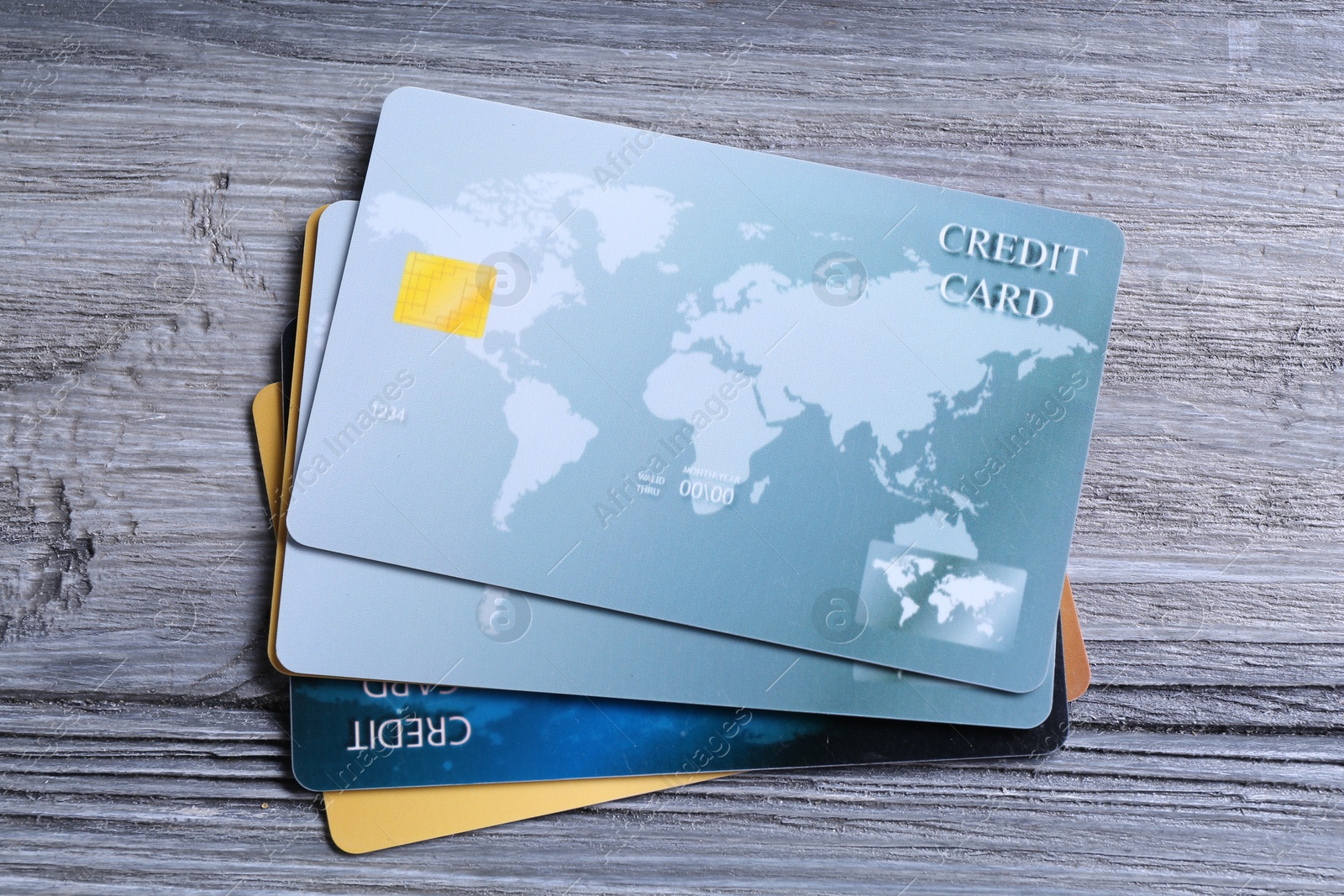 Photo of Credit cards on grey wooden table, top view