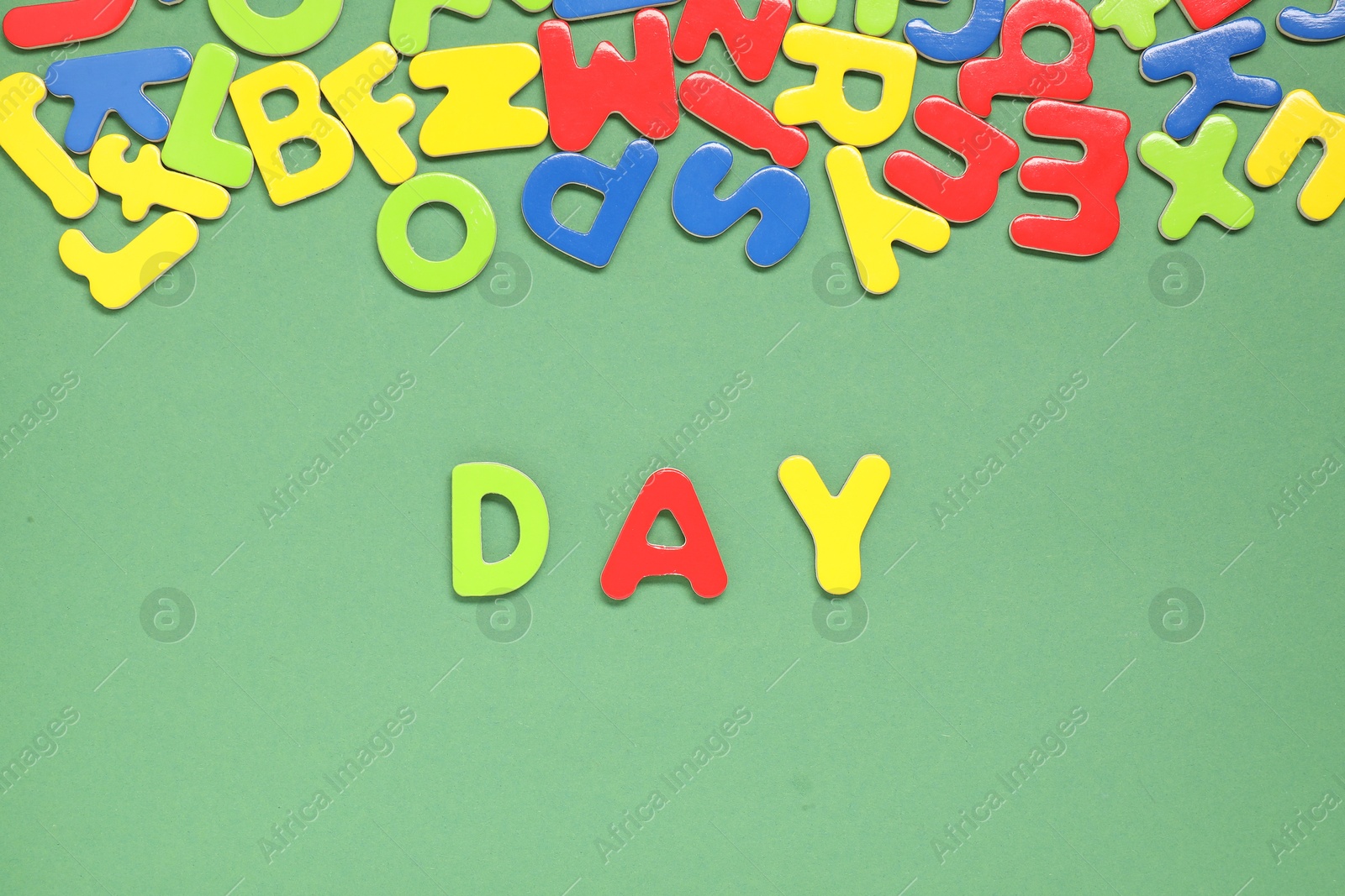 Photo of Word Day made of magnetic letters on green background, flat lay. Learning alphabet